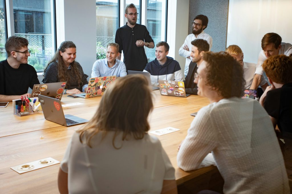 A team meeting around a large board room table.